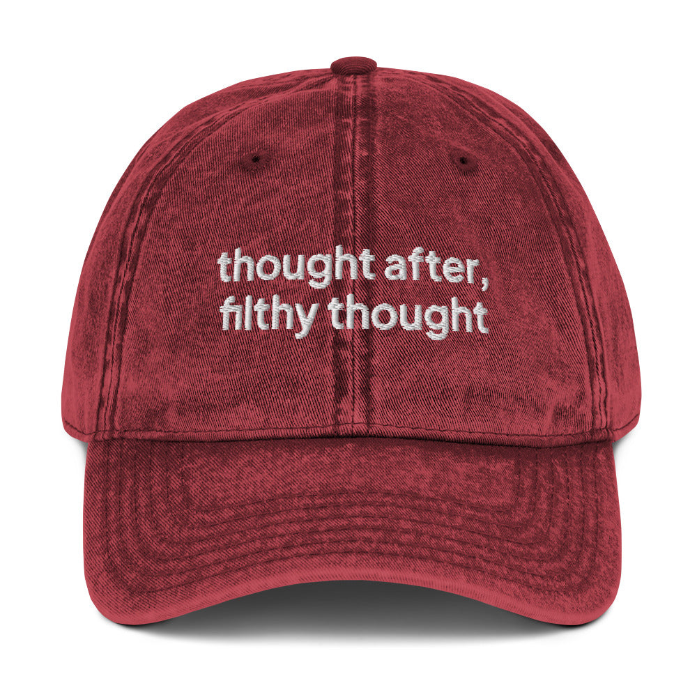 Burgundy washed out vintage cotton twill dad cap with the slogan 'thought after, filthy thought' embroidered on it. 