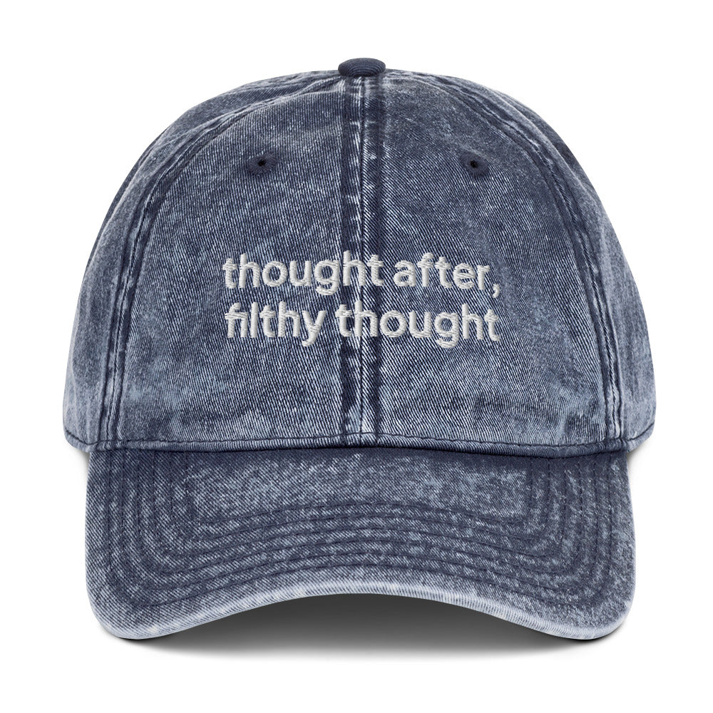 Navy blue washed out vintage cotton twill dad cap with the slogan 'thought after, filthy thought' embroidered on it. 