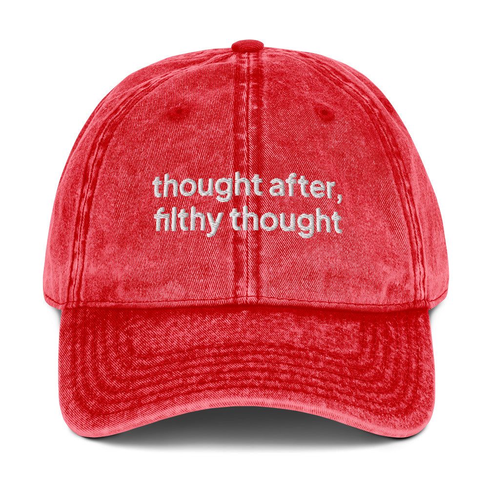 Red washed out vintage cotton twill dad cap with the slogan 'thought after, filthy thought' embroidered on it. 